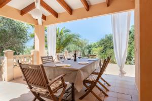 an outdoor dining room with a table and chairs at Casa Antonio Invierno in Cala Llombards