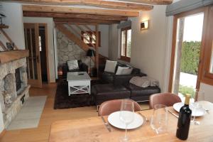 a living room with a table and a couch at Mayen de l'Art d Vivre in Crans-Montana