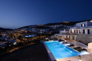 a view of a building with a swimming pool at night at Wonderful Villa Chrysta in Mikonos