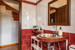 a bathroom with a sink and a mirror at Casa Florenta G3 in Cangas de Onís +17 photos