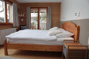 a bedroom with a bed with white sheets and pillows at Mayen de l'Art d Vivre in Crans-Montana
