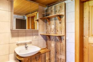 a bathroom with a sink and a mirror at The Farm in Westendorf