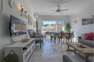 a living room with a couch and a table at Burriana Casa Playa in Nerja
