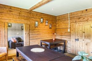 a dining room with wooden walls and a table at The Farm in Westendorf