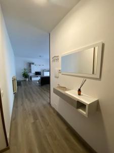 a living room with a sink and a mirror on a wall at Appartamento Primavera in Cazzago San Martino