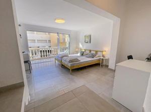 a bedroom with a bed and a balcony at Burriana Casa Playa in Nerja +21 photos