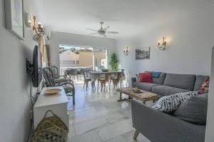 a living room with a couch and a table at Burriana Casa Playa in Nerja