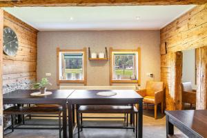 a dining room with two tables and a chair at The Farm in Westendorf +23 photos