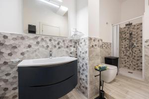 a bathroom with a sink and a shower and a toilet at Sole e Amore in Casteldaccia +26 photos