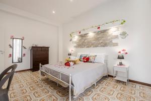 a bedroom with a bed and a brick wall at Sole e Amore in Casteldaccia