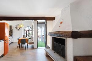 a living room with a fireplace and a dining room at Mansarda Vialba in Germignaga