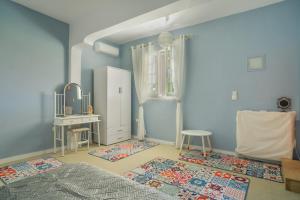 a bedroom with a bed and a white refrigerator at Palati in Kefallonia