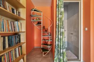 a room with orange walls and a book shelf at Palati in Kefallonia