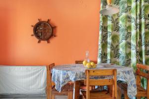 a dining room with a table with fruit on it at Palati in Kefallonia +19 photos