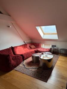 a living room with a red couch and a window at Cosy Studio in Mechelen by Studio Pila in Mechelen