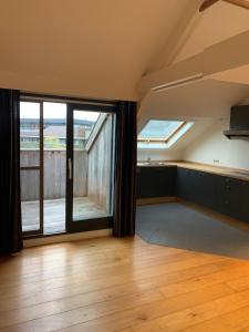 an empty living room with a large window at Cosy Studio in Mechelen by Studio Pila in Mechelen