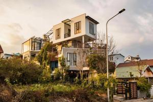 a house on top of a building at BeYouth Hotel Dalat Valley View in Da Lat