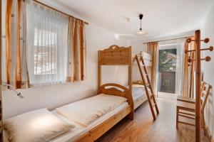 a room with two bunk beds and a window at Ferienwohnung Innerwalten 200 in San Leonardo in Passiria