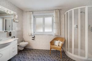 a bathroom with a sink toilet and a window at Ferienwohnung Innerwalten 200 in San Leonardo in Passiria +16 photos