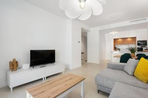 a living room with a tv and a couch at Horus 054 in Torre del Mar