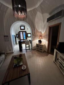a living room with a table and a couch at Dammuso Cristoforo Colombo in Pantelleria