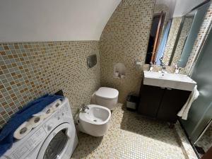 a bathroom with a washing machine and a sink at Dammuso Cristoforo Colombo in Pantelleria +10 photos