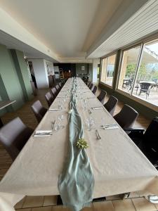 a large long table in a room with chairs at Logis Hôtel de la Bruyere in Pouzauges