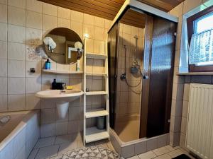 a bathroom with a shower and a sink and a mirror at Haus der Monteure in Stadtbergen