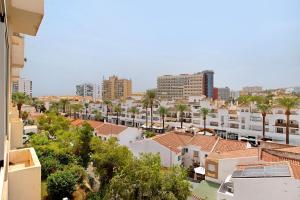a view of a city with palm trees and buildings at Prealsa Benalmádena in Benalmádena