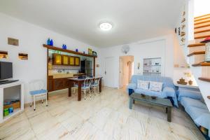 a living room with a blue couch and a table at Can Blau in Portocolom +22 photos