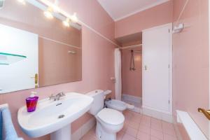 a bathroom with a white sink and a toilet at Can Blau in Portocolom