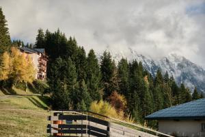 a fence in a field with a mountain in the background at Studio Au Pieds Pistes Ski Collet in Allevard