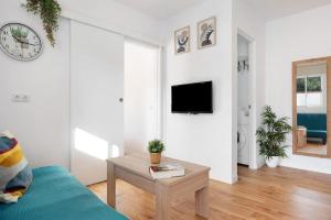 a living room with a couch and a table at Zahora Qg in Barbate +13 photos