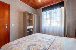 a bedroom with a bed and a window at Montée du Boiloa - Bielle, Laruns in Bielle