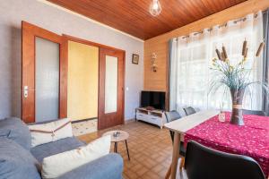 a living room with a couch and a table at Montée du Boiloa - Bielle, Laruns in Bielle