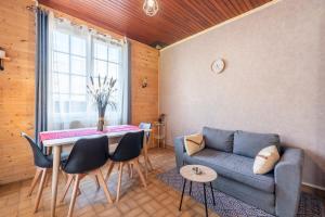 a living room with a couch and a table at Montée du Boiloa - Bielle, Laruns in Bielle
