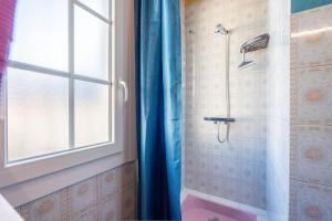 a bathroom with a shower with a blue shower curtain at Montée du Boiloa - Bielle, Laruns in Bielle +17 photos