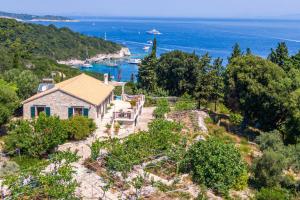 a house on a hill with a view of the ocean at Villa Iremia Antipaxos in Antipaxos