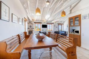 a living room with a wooden table and chairs at Villa Iremia Antipaxos in Antipaxos