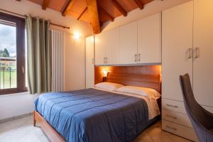 a bedroom with a bed and a large window at Villette di Contignano in Radicofani +71 photos