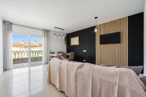 a bedroom with a large bed and a dining room at Montserrat in Miami Platja