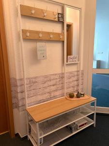 a dressing room with a mirror and a table at Wohnung Weida 2 in Riesa