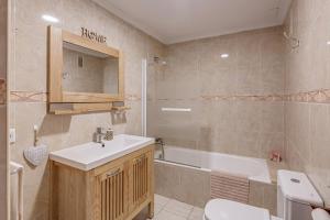 a bathroom with a sink and a tub and a toilet at Mariners in Alcudia +18 photos