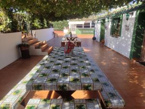 a patio with tables and benches in a building at Agroturismo El Serrano in Moratalla