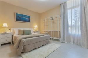 a bedroom with a bed and a large window at Cala Sunrise in Los Realejos