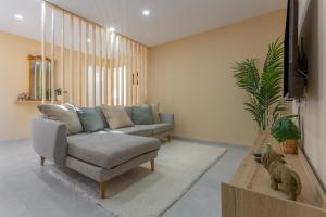 a living room with a couch and a tv at Cala Sunrise in Los Realejos