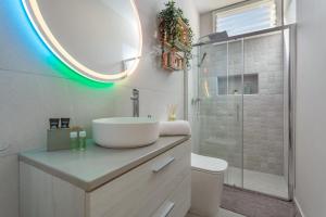 a bathroom with a sink and a toilet and a mirror at Cala Sunrise in Los Realejos +29 photos