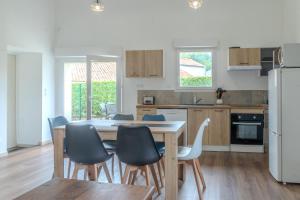a kitchen with a table and chairs in a kitchen at Gite Berclois in Bercloux