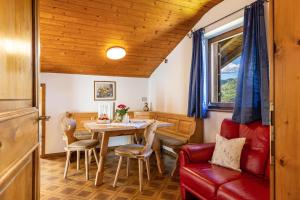 a dining room with a table and chairs at Pardellerhof Tschafonblick in Campodazzo