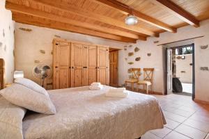 a bedroom with a large bed and wooden ceilings at Casa Rural Andresito in Pájara